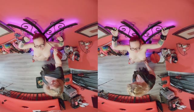 Redhead Vexxy Bliss poses in an indoor setting for this non POV VR video featuring medium sized tits and fetish themes.