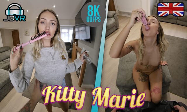 Kitty Marie, a British model with medium breasts, touches her chest in a mobile hairdresser setting for this JimmyDraws VR POV video.