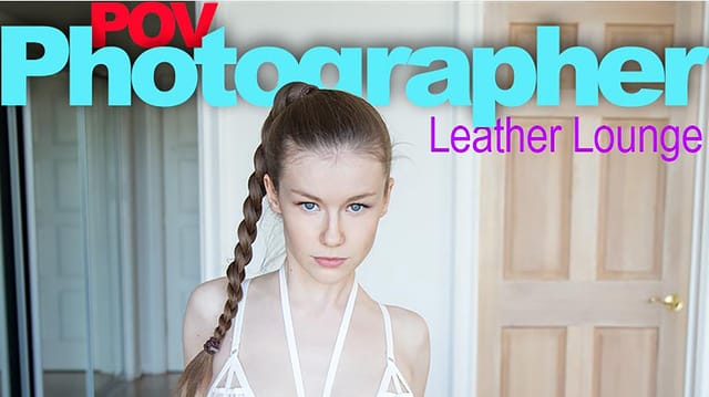 Emily Bloom poses in a leather lounge during a solo VR 4K 60 FPS POV photographer shoot by EmilyBloom.