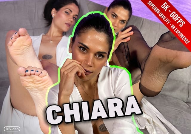 Brunette Chiara in a solo VR 4K scene tries on tights while standing in a studio setting with 60 FPS passthrough.