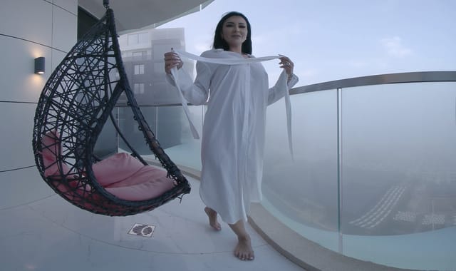 Brunette Mistress Kennya teases on a vacation balcony in this 4K VR fetish scene by HouseOfLust
