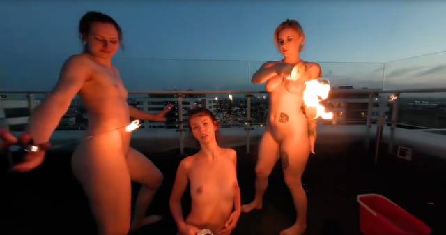 Lea Rebeka Ruby fire dances with models Melonie and VRgoddess on a rooftop in this 4K 180 degree VR POV video