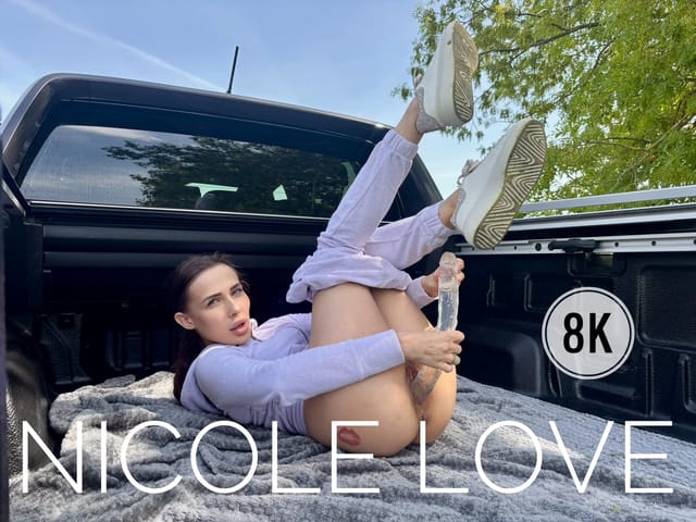 Brunette Nicole Love masturbates with a large dildo on a pickup truck in a 4K outdoor POV VR scene.